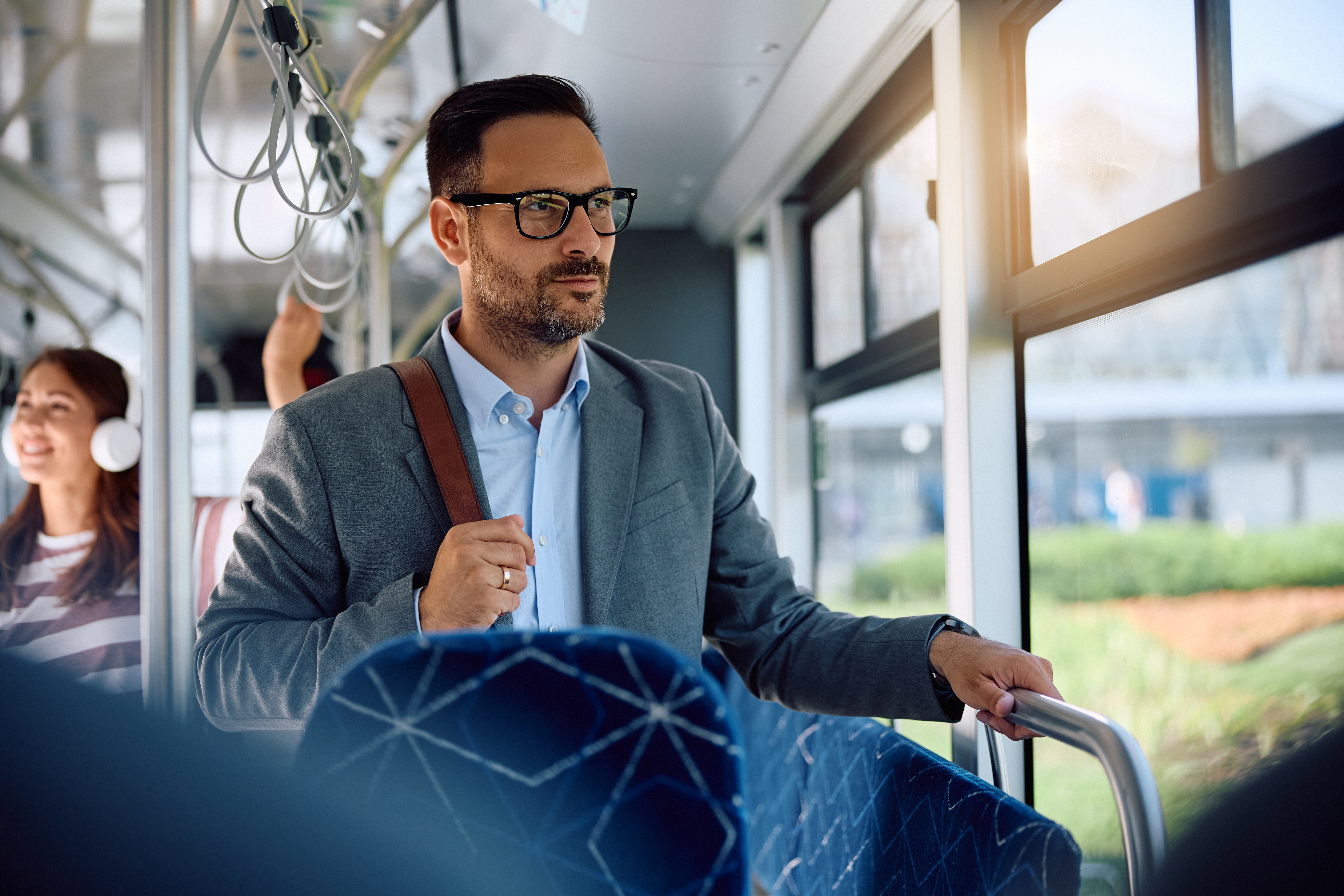 Man commuting to work with bag on bus