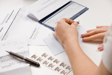 Person putting check in envelope