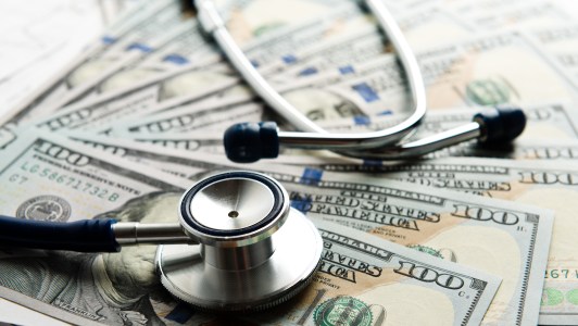 Expensive healthcare, stethescope and hundred dollar bills