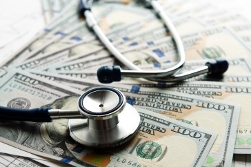 Expensive healthcare, stethescope and hundred dollar bills