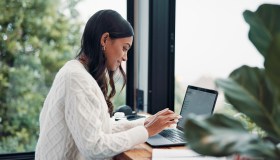 Woman, email or remote work in home with laptop for HR support, payroll or benefits administration. Person, typing or review in house with computer for employee policy, management report or planning.