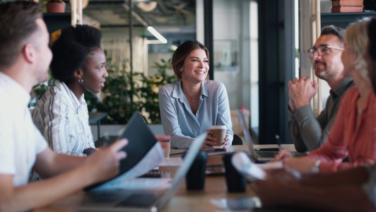 Group of employees talking, planning, sitting at table