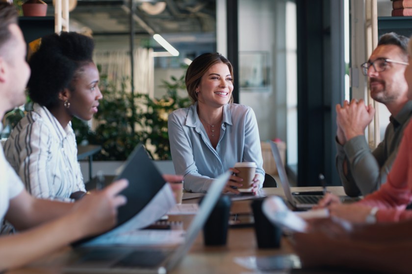 Group of employees talking, planning, sitting at table