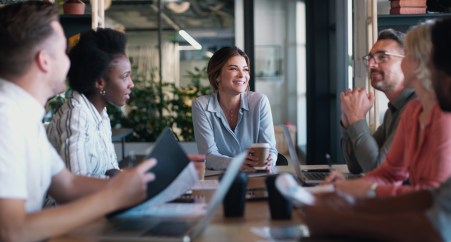 Group of employees talking, planning, sitting at table