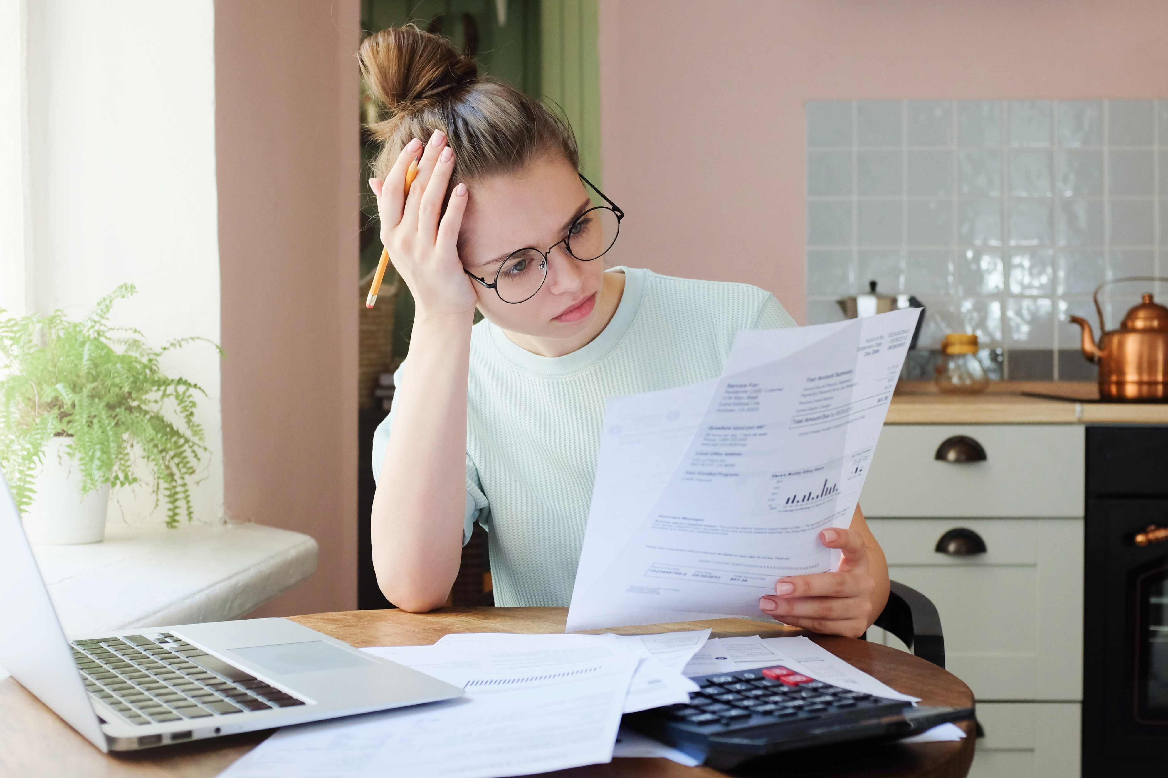 Indoor shot of young woman looking at financial statements.