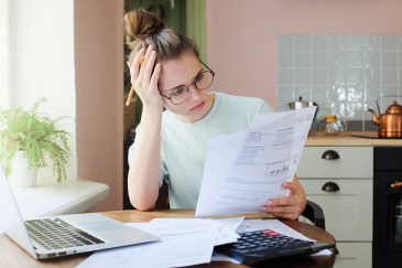 Indoor shot of young woman looking at financial statements.