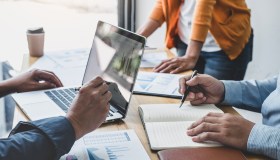 Business team meeting to conference, collaboration discussing working analyzing with financial data and marketing business strategy project, presentation and brainstorming to making profit of company.