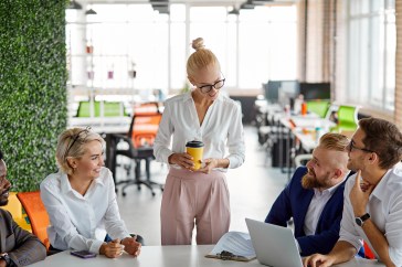 Employees talking, nice office, drinking coffee, collaborating