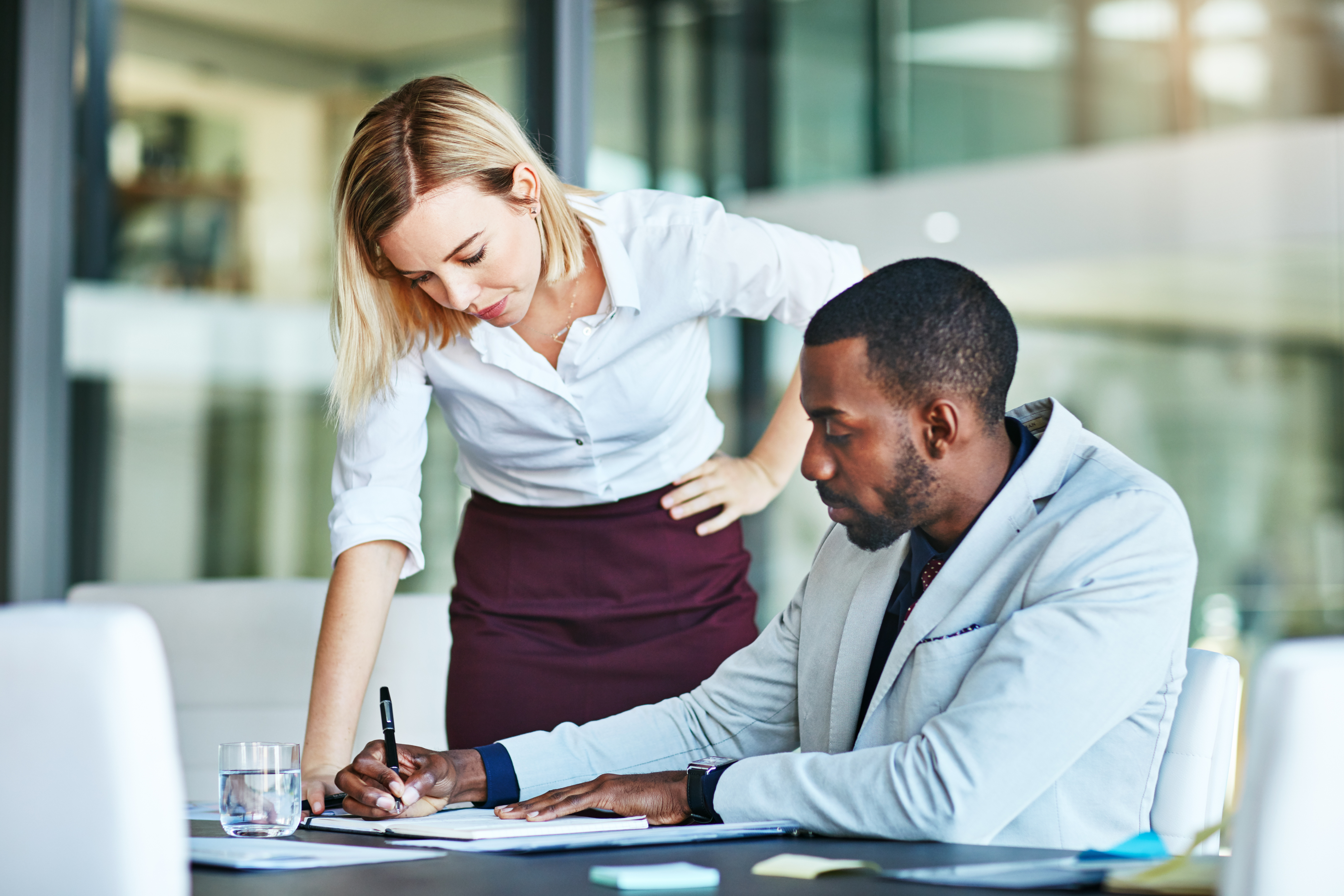 Two employees helping each other