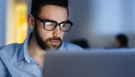 Bearded Man Busy Working Late