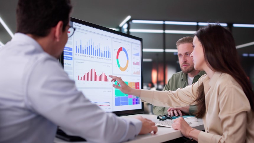 Businesswoman Managing Company Data Using Analytics Dashboard