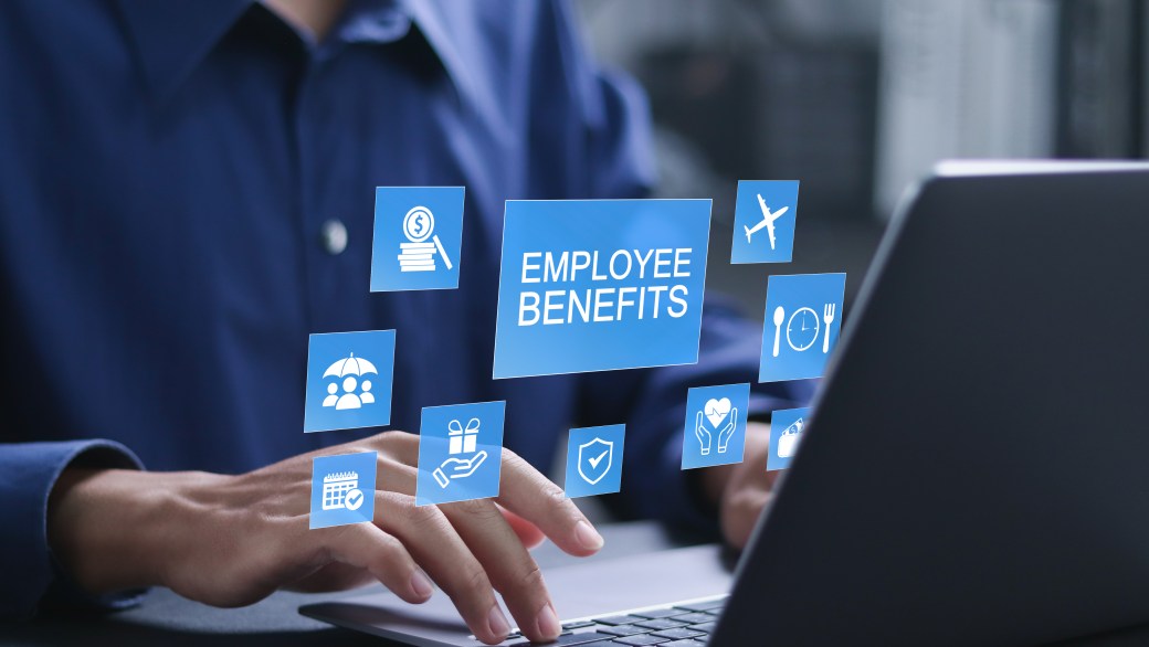 Employee benefits concept. Insurance, paid vacation, office perks, Fringe benefits for employee engagement. Businessman using laptop with employee benefits icon on virtual screen.