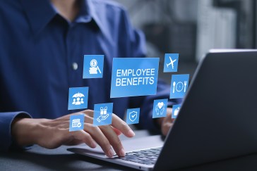 Employee benefits concept. Insurance, paid vacation, office perks, Fringe benefits for employee engagement. Businessman using laptop with employee benefits icon on virtual screen.