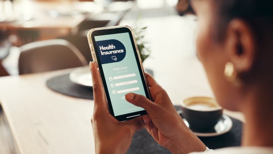Phone screen, health insurance and hands of woman for digital application, app and check in. Claims status, membership benefits and medical cover with person for login and online review in cafe