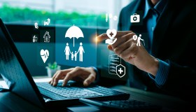 Digital insurance technology concept with businessman hand selecting family protection, health, finance, and retirement.