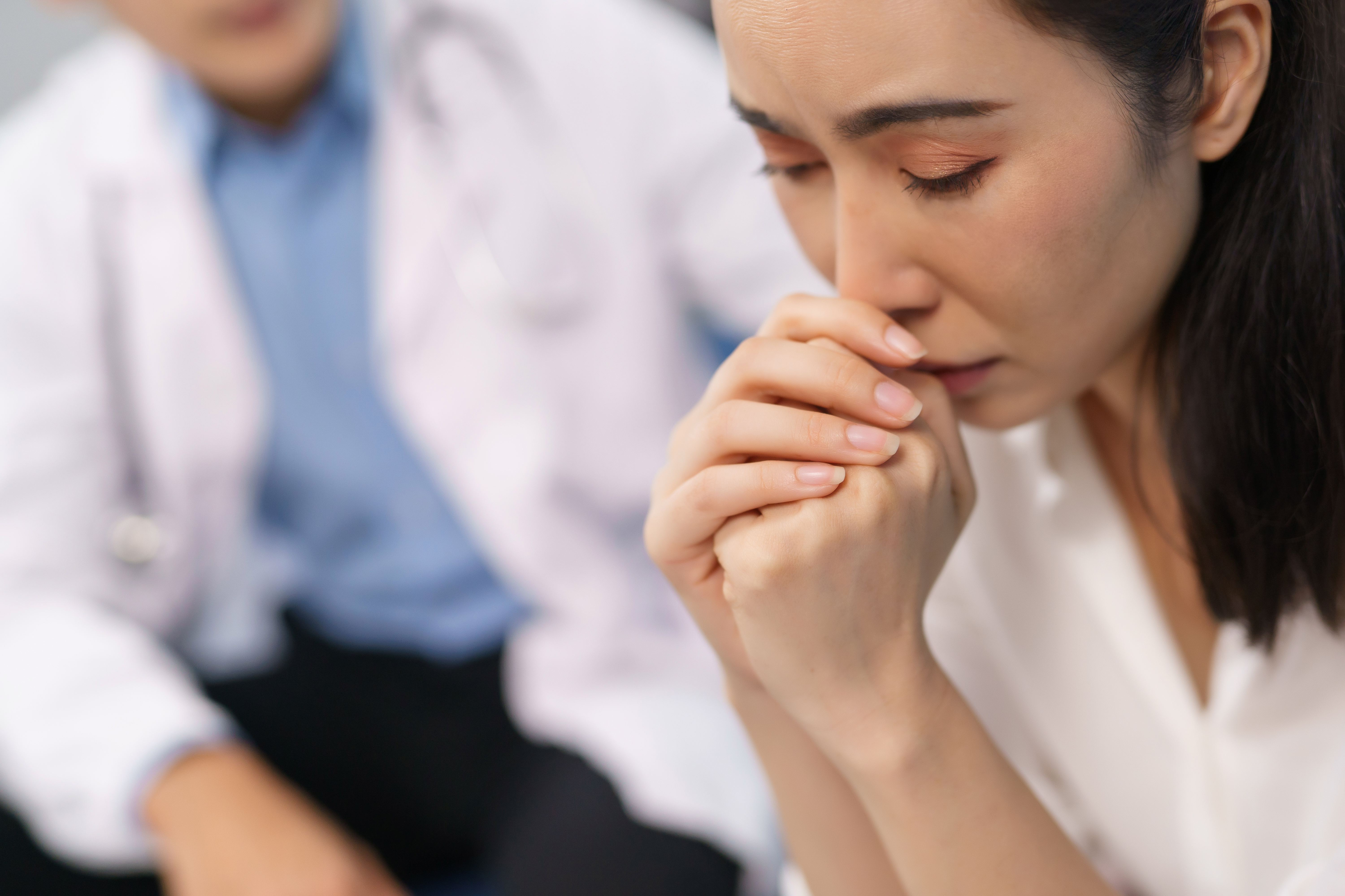 Woman patient feeling sad during medical consultation
