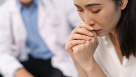Woman patient feeling sad during medical consultation