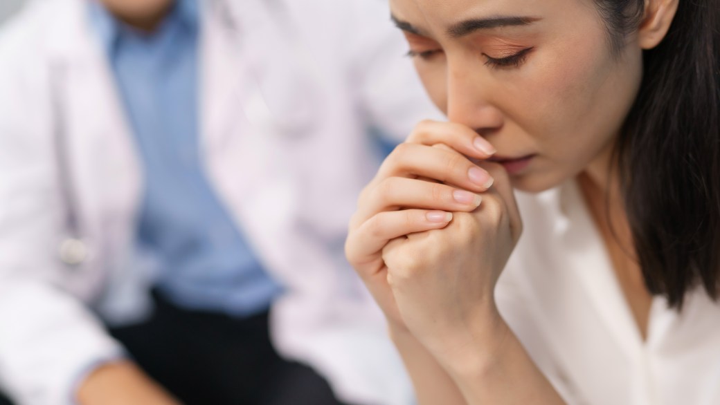 Woman patient feeling sad during medical consultation