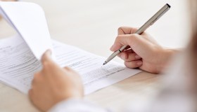Crop person signing contract