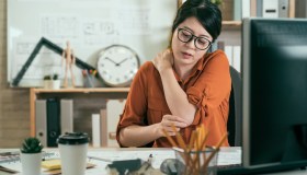 woman employee suffer shoulder pain